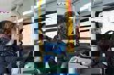People smiling on a bus
