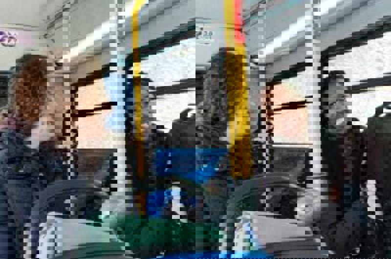 People smiling on a bus