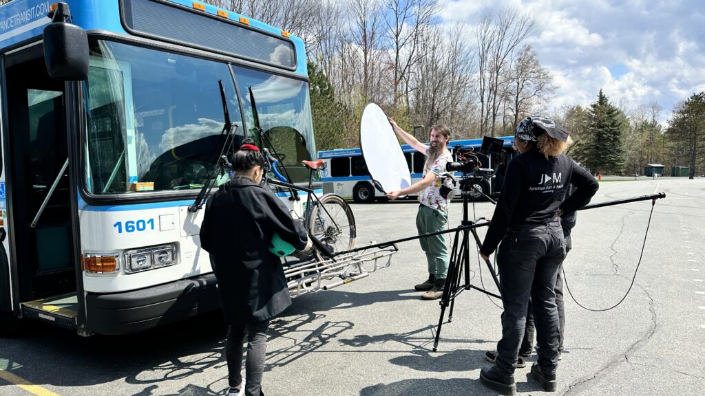 Filming in front of a bus